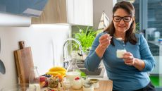 middle-aged woman eats a protein-rich yoghurt