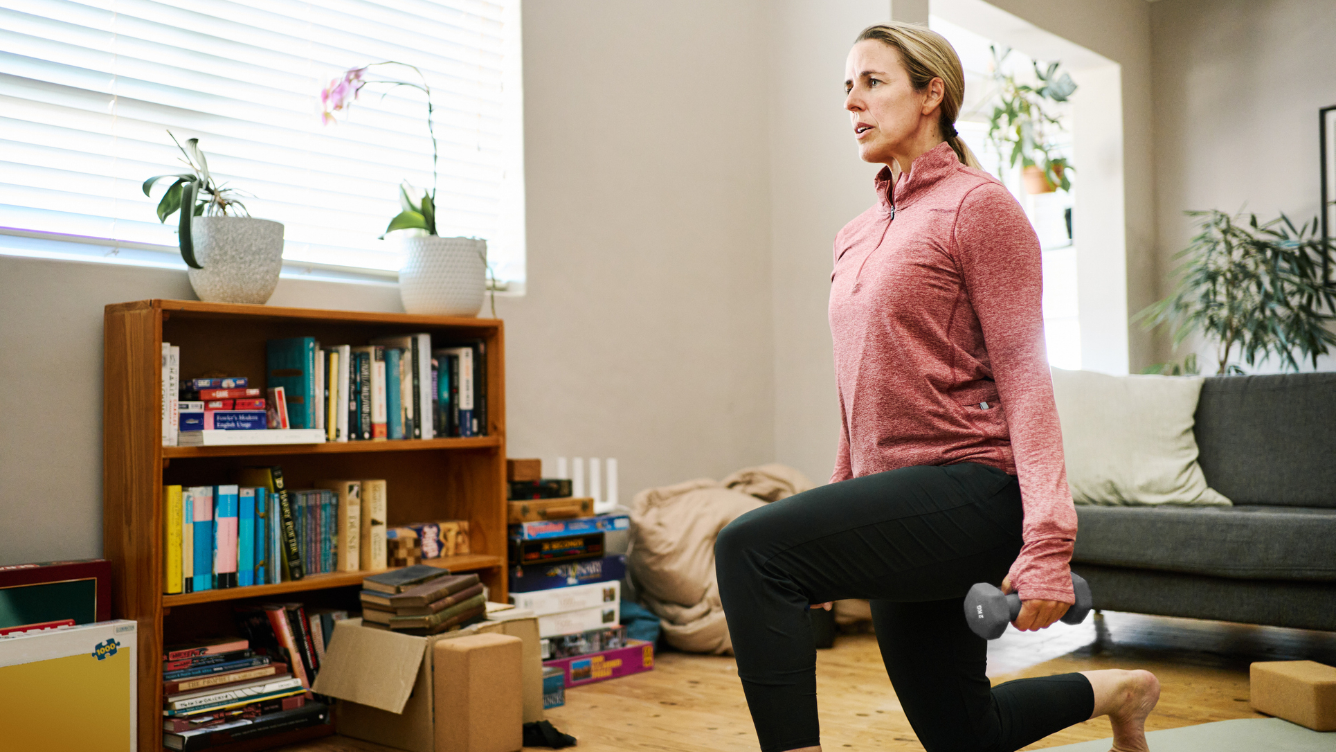 Woman exercising with dumbbells at home