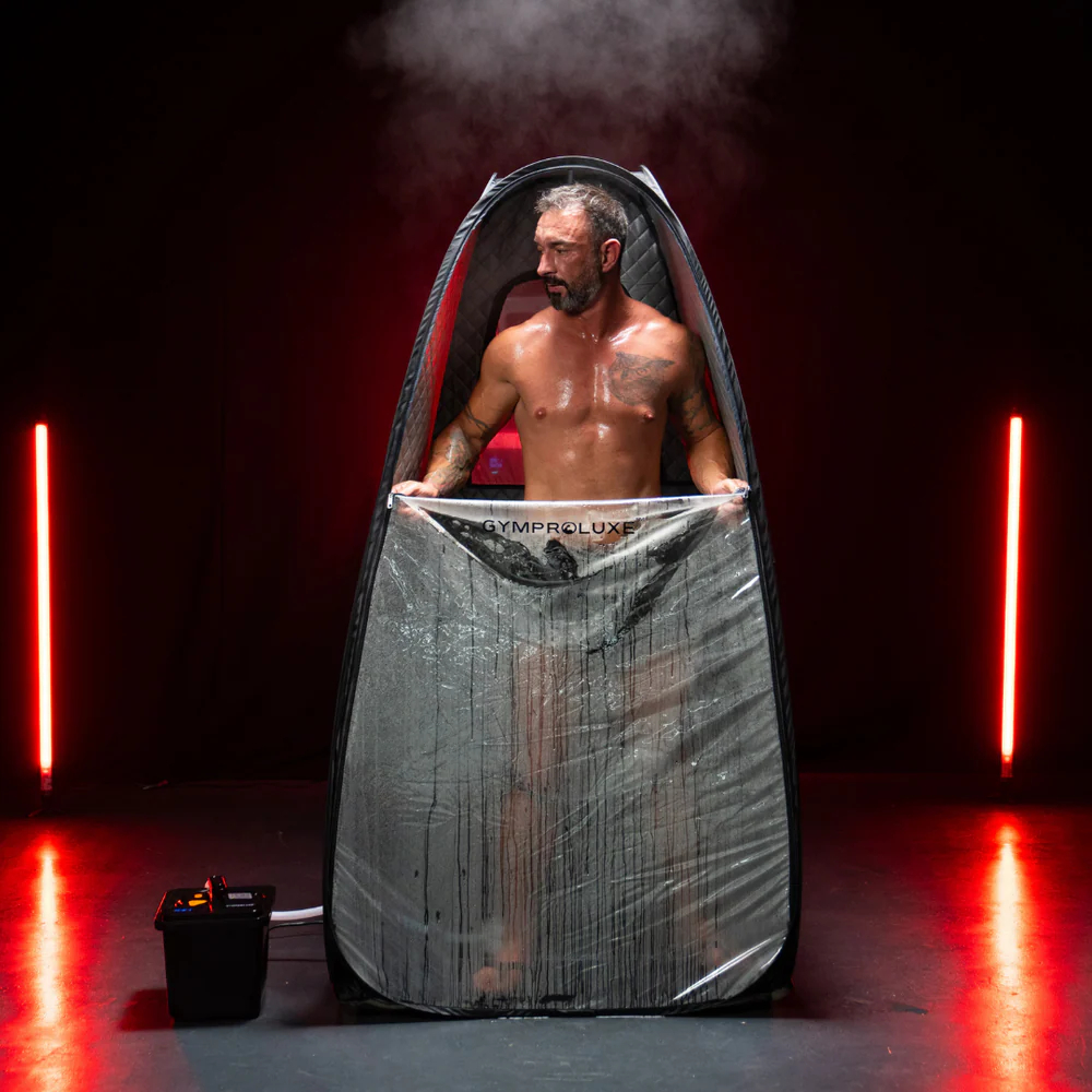 Man zipping up sauna pod