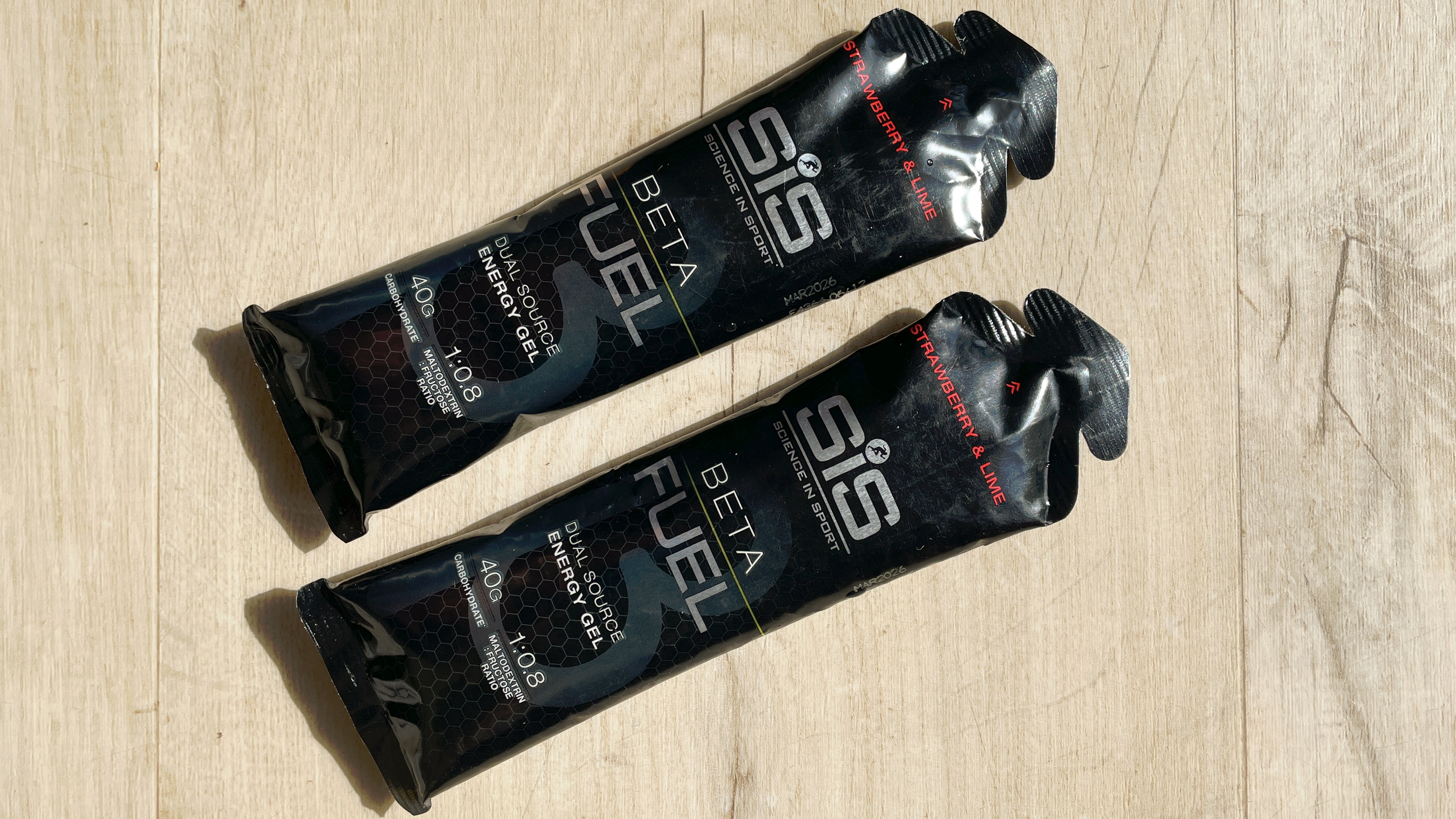 Two SIS Beta fuel running gels on a wooden floor