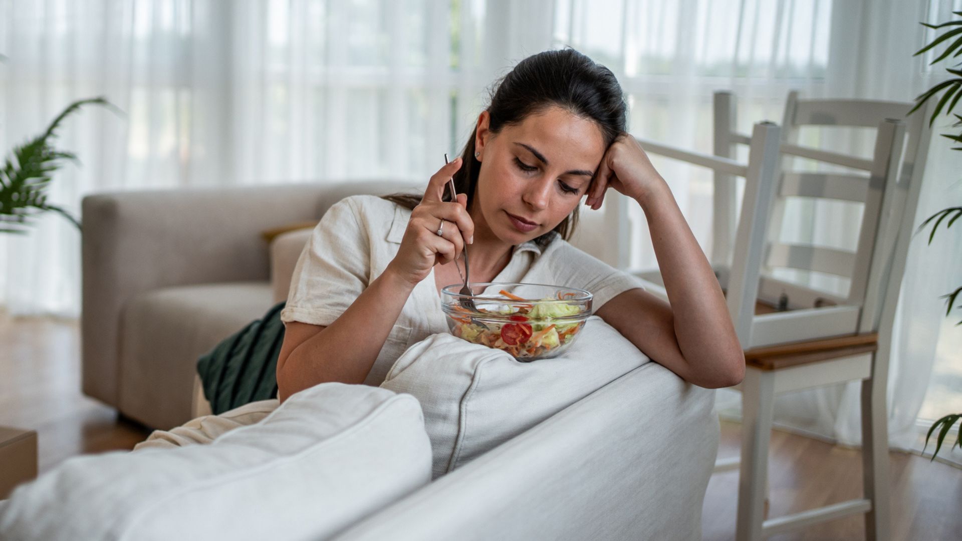 woman stares at unappealing salad 