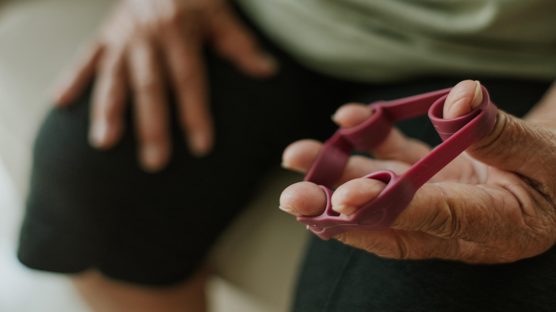 Close-up of a hand using rubber finger stretcher